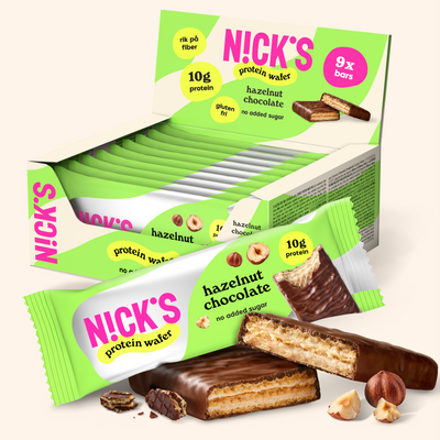 NICK'S Hazelnut Chocolate Protein Wafer 9-pack box with individually wrapped wafers and chocolate-coated wafer pieces.